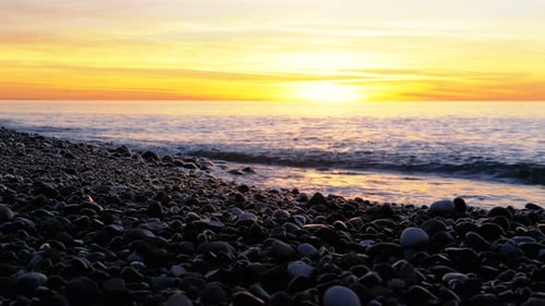 Beautiful Sunset Over the Sea Near the Stony Shore