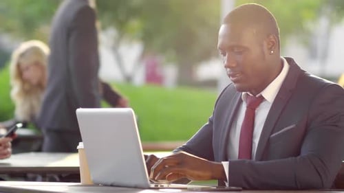 Business People Working Outside on Laptops in Daytime
