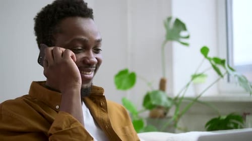 Smiling Man Talking on Cell Phone Indoors