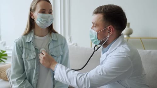 Doctor Examines Patient with Stethoscope during Consultation