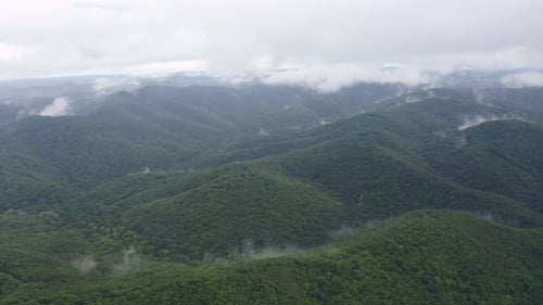 Drone flight over green mountain slopes