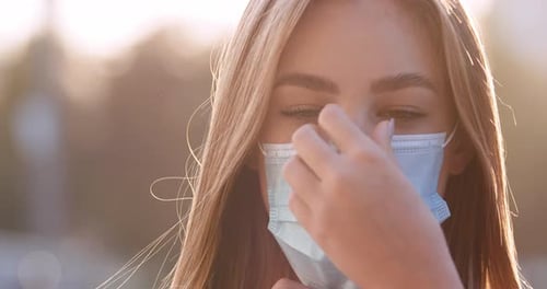 Close Up Portrait of Caucasian Beautiful Young Woman in Medical Mask Standing Outdoor on Street in