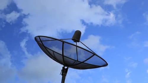 Satellite Dish against Blue Sky with Clouds