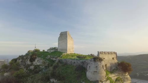 Aerial View of Castle on Hillside Overlooking the Sea