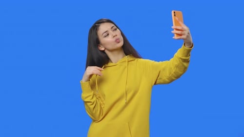 Stylish Woman Taking Selfies Posing with Cellphone