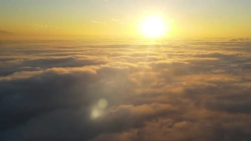 Aerial View Above Clouds at Sunrise