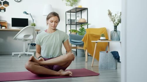 Woman Doing Yoga and Stretching at Home