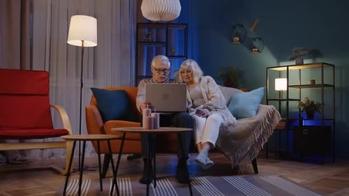 Senior Couple Watching Laptop Together at Home