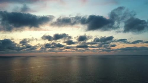 Flying Right Over Sea After Sunset. Beautiful Sea Sunset Flyover Aerial 4K Drone Shoot