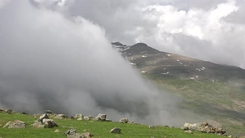 Mist Shrouded Mountain Landscape Under Cloudy Sky