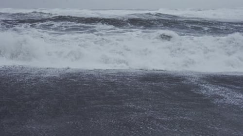 White Storm Waves Crashing Onto Black Sand Beach