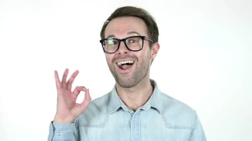Man Gestures Okay Sign in Front of White Background