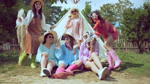 Group of Women Posing near Decorative Tent