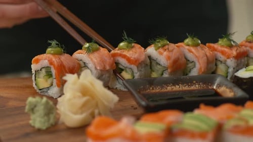 Dipping sushi into soy sauce