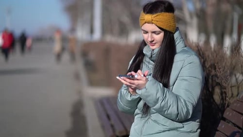 Young Woman Texting on the Smartphone