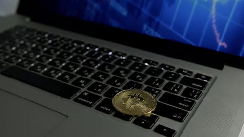 Bitcoin on Laptop Keyboard Shows Digital Trading Screen