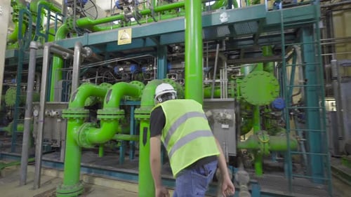 Engineer checking Valves in factory.