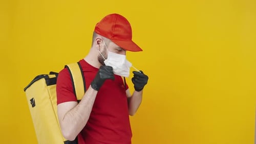 Delivery Man Puts On Face Mask for Safety