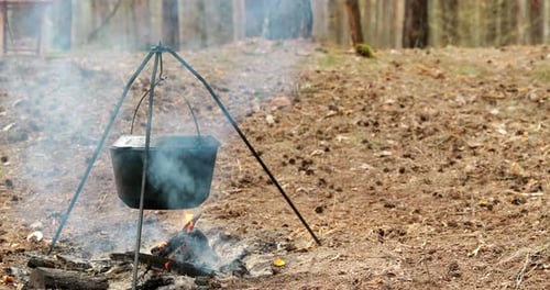 Old Retro Camp Saucepan Boiled Water For Soup Preparation On A Fire In Forest