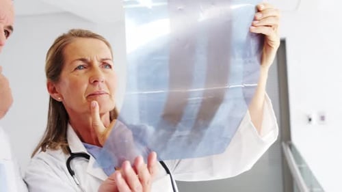 Doctors checking x-ray report