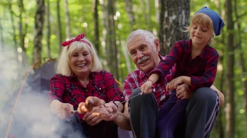 Grandparents and Child Camping, Roasting Sausages