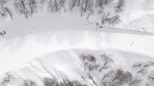 Aerial view of the ski resort with snowy mountain slopes and winter trees.