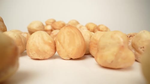 Peeled Hazelnuts on a White Surface