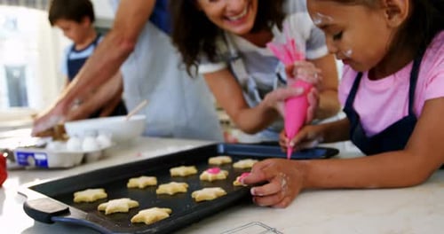 Family Decorating Star-Shaped Cookies in Home Kitchen