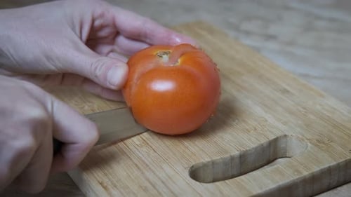 Tomato Sliced on Cutting Board at Home