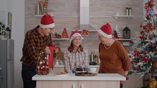 Girl Receives Christmas Gifts from Grandparents at Home