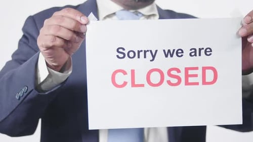 Businessman Posts Sign On Window We Are Closed