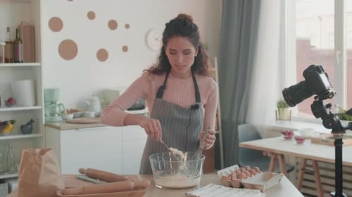 Woman Making Batter in Kitchen for Online Video