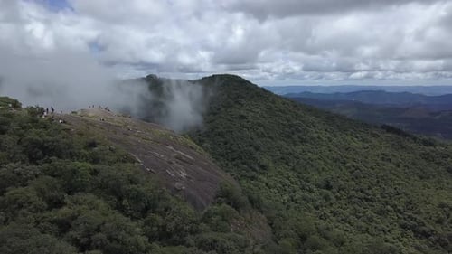 Majestic Mountain Range Under Cloudy Sky Aerial View