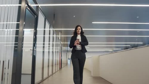 Confident Business Woman Walking Down the Hall in an Office Building