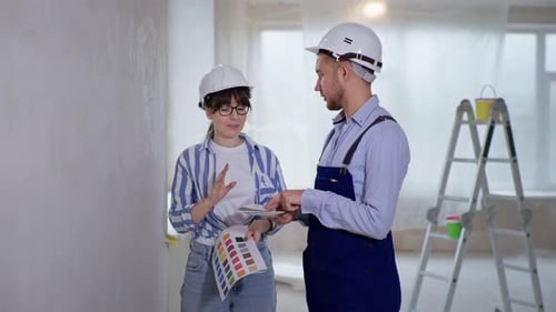 Two Adults Discussing Interior Paint Choices