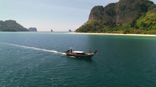 Longtail Boat Cruising Turquoise Waters in Thailand