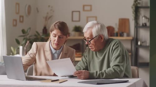 Financial Advisor Consults with Senior Man at Home