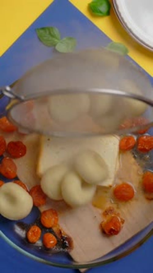 Preparing Baked Feta Pasta with Cherry Tomatoes and Gnocchi