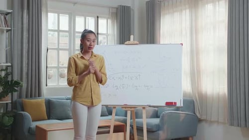 Woman Explaining Math Equations on Whiteboard