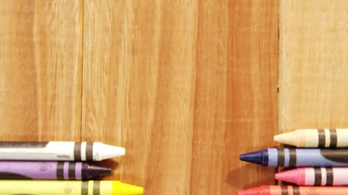 Colorful Crayons Arranged on Wooden Tabletop