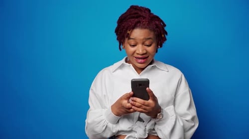 Excited Woman Reacts to Smartphone News