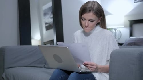 Woman Works on Laptop at Home