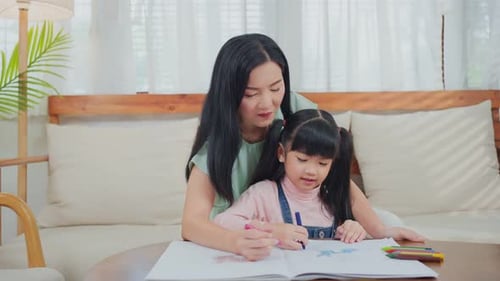 Mother and Child Drawing Together at Home