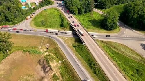 Aerial View of Road Intersection with Fast Moving Heavy Traffic on City Streets