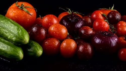 Fresh Cucumbers and Tomatoes with Water Droplets