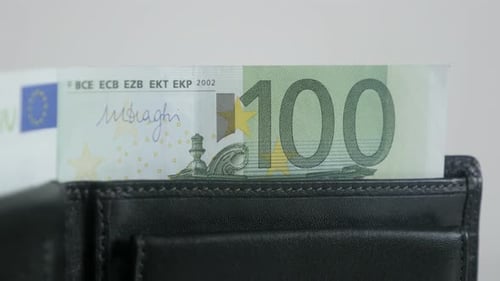 Green 100 euro banknotes in bi-fold money case 3840X2160 UltraHD tilting footage - Paper money in bl