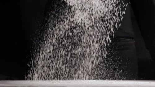 Flour Pouring onto Flat Surface in Slow Motion