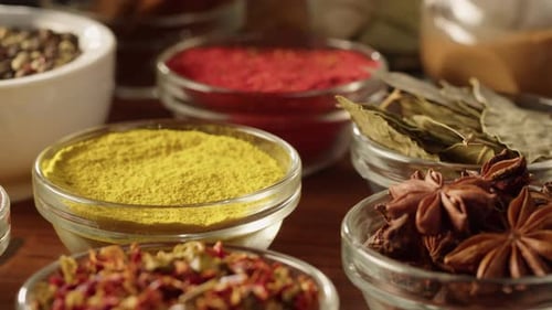 Assorted Spices in Glass Bowls on Wood Surface