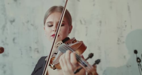 Woman Plays Violin with Elegance and Skill