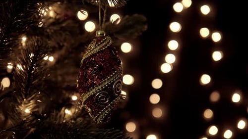 Elegant Christmas Ornament Hanging on Lit Tree